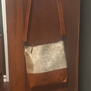 Leather and cow hide cross body purse.